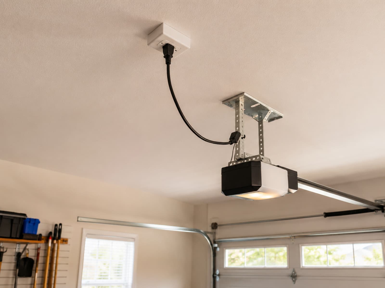A ceiling-mounted outlet powering a garage door opener