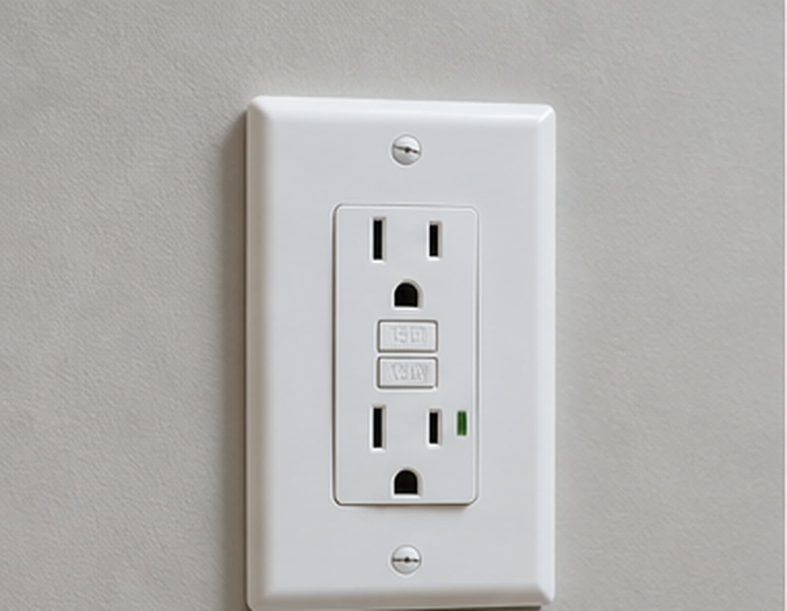 A white GFCI outlet with test and reset buttons installed on a wall